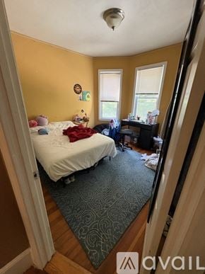Boston apartment for rent - A bedroom with a bed, desk, and window.