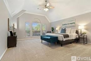 Plano house for rent - A bedroom with a large bed and a ceiling fan.