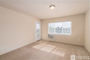 Spokane Valley apartment for rent - A spacious room with a window and a door.
