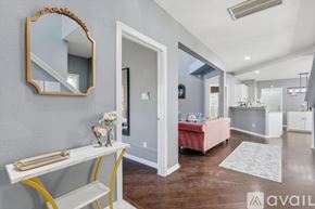 Lewisville house for rent - A bedroom with a pink bed and a mirror on the wall.