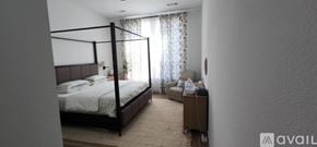 Justin house for rent - A bedroom with a large bed and a smaller bed in the corner.