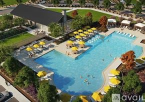 Justin house for rent - A large outdoor swimming pool surrounded by yellow umbrellas and people enjoying the water.