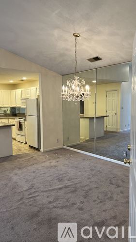 Louisville apartment for rent - A modern kitchen with a chandelier and a view of the dining area.