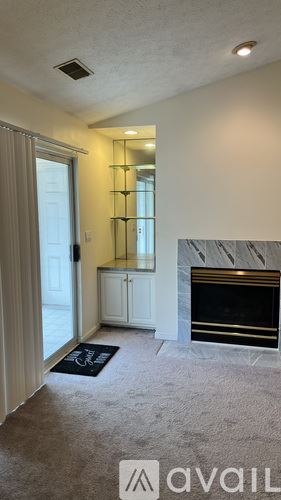Louisville apartment for rent - A room with a fireplace and a mirror on the wall.
