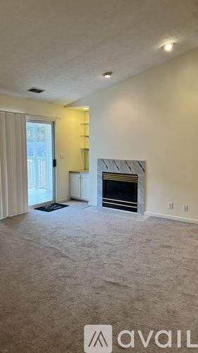 Louisville apartment for rent - A living room with a fireplace and a large window.