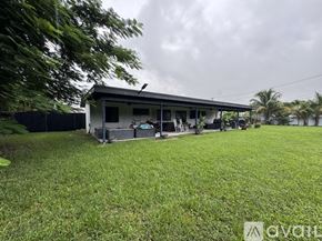 Miami house for rent - A house with a green lawn in front of it.