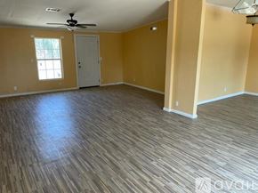 Atascosa apartment for rent - A room with a ceiling fan and wooden flooring.