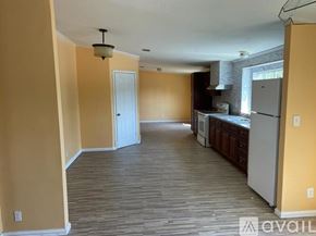 Atascosa apartment for rent - A kitchen area with a refrigerator, oven, and cabinets.