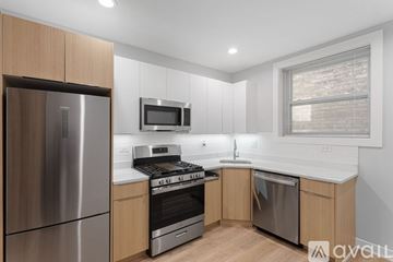 Chicago apartment for rent - A modern kitchen with wooden cabinets and stainless steel appliances.
