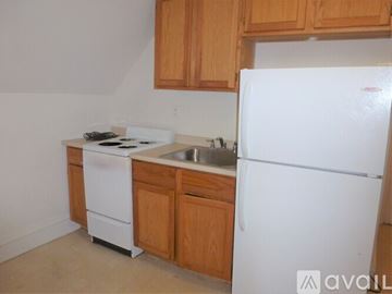 Burlington apartment for rent - A kitchen with a white fridge, white stove and white dishwasher.
