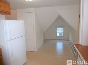 Burlington apartment for rent - A kitchen with a white refrigerator and a window.