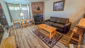 Red Lodge condo for rent - A living room with a fireplace and a couch.