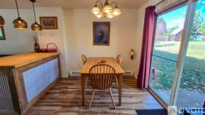 Red Lodge condo for rent - A dining room with a wooden table and chairs.