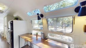 Cat Spring apartment for rent - The interior of a camper van with a table and chairs.