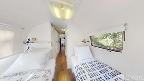 Cat Spring apartment for rent - A bedroom with a bed and a window with a view of trees.