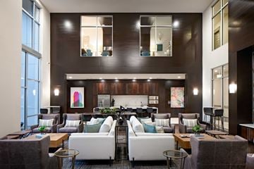 Dallas apartment for rent - A modern living room with a large couch and a coffee table.