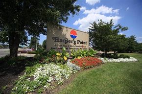 Cincinnati apartment for rent - a sign forhapers point in front of a garden of flowers