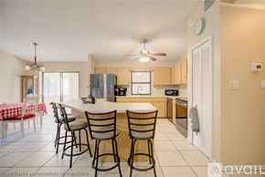 Sebring house for rent - A kitchen with a table and chairs set up for dining.