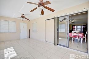 Sebring house for rent - A room with a ceiling fan and sliding glass doors leading to a dining area.