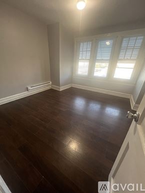 Philadelphia house for rent - A room with wooden flooring and a window with blinds.