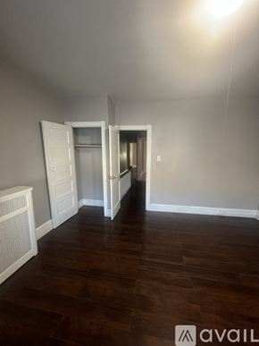 Philadelphia house for rent - A room with a wooden floor and a white door.