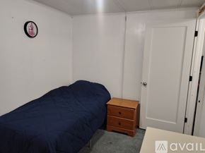Clearwater apartment for rent - A bedroom with a bed, chair, and wooden table.