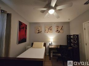 Davenport house for rent - A bedroom with a bed, a chair, and a TV.