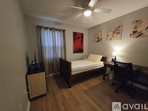 Davenport house for rent - A bedroom with a bed, nightstand, and a ceiling fan.