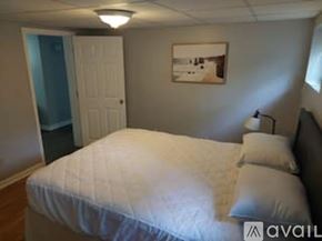 Smithfield apartment for rent - A bedroom with a bed, pillow, and a picture on the wall.