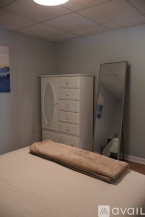 Smithfield apartment for rent - A red building with a green railing and a small garden area.