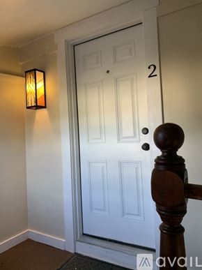 Aberdeen apartment for rent - A white door with a black handle and a wooden post to the right.