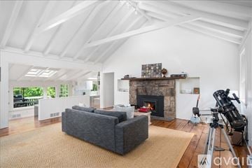 Norwalk house for rent - A living room with a grey couch and a fireplace.