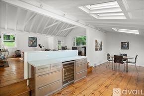Norwalk house for rent - A kitchen with a white countertop and wooden floors.