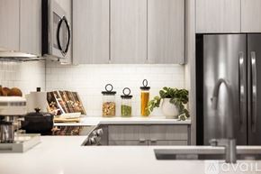 Denver apartment for rent - A kitchen with a white countertop and a stainless steel refrigerator.