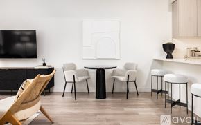 Denver apartment for rent - A modern living room with a white wall and a black and white artwork.
