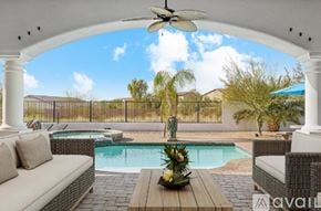 Mesa house for rent - A patio with a pool and a white sofa.