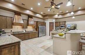 Mesa house for rent - A kitchen with a large island and a refrigerator.