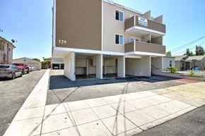 Redwood City apartment for rent - a view of the side of a building with a street in front of it