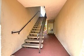 Redwood City apartment for rent - a set of stairs leading up to a hallway with a railing