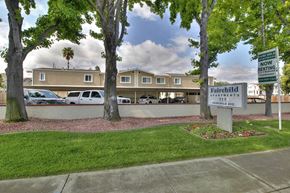 Mountain View apartment for rent - A sign for Fairchild Apartments stands in front of a building.