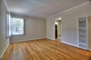 Mountain View apartment for rent - A room with wooden floors and a window with blinds.