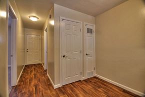 Mountain View apartment for rent - A hallway with three doors and wood floors.