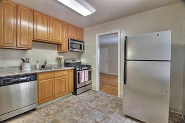 Mountain View apartment for rent - a kitchen with stainless steel appliances and wooden cabinets