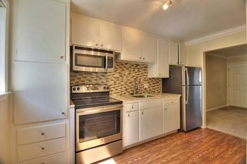 Mountain View apartment for rent - a kitchen with stainless steel appliances and white cabinets