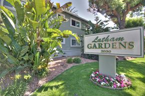 Mountain View apartment for rent - A sign for Latham Gardens stands in a well-kept garden.
