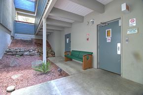 Belmont apartment for rent - A small courtyard with a bench and a door.