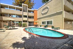 Redwood City apartment for rent - A pool in a courtyard surrounded by buildings.