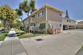 Sunnyvale apartment for rent - A building with a beige facade and a red pole in front.