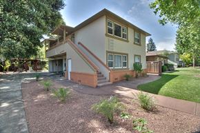 Menlo Park apartment for rent - A house with a brown and beige exterior and a red staircase.