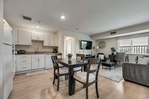 Richardson house for rent - A modern kitchen with a dining table and chairs.